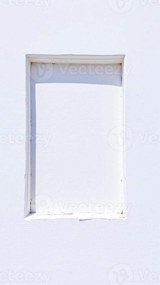 recessed white window frame on a textured wall photo