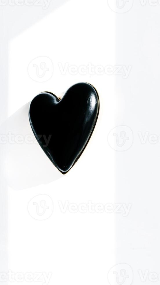 black heart-shaped object on a white surface photo