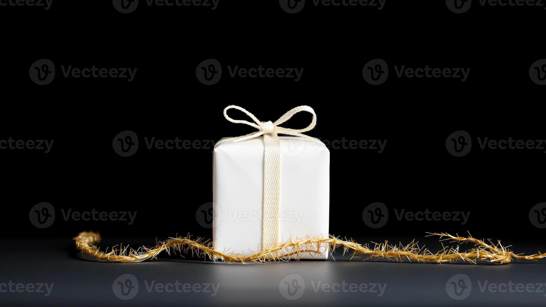 simple white gift box decorated with a golden garland photo