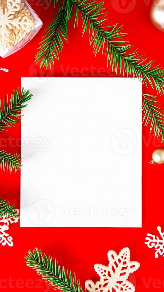 white card with pine sprigs snowflakes on red background photo