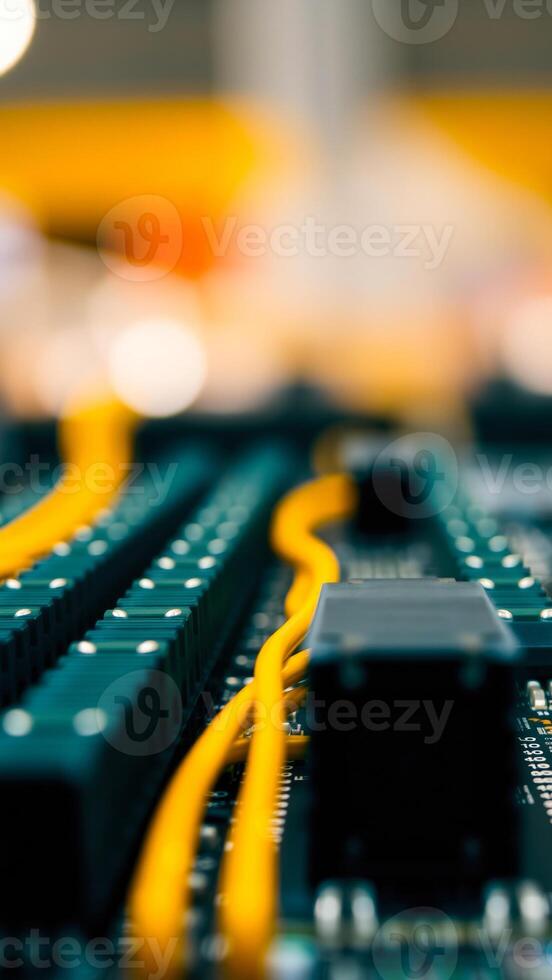 close- a teal circuit board with yellow wires photo