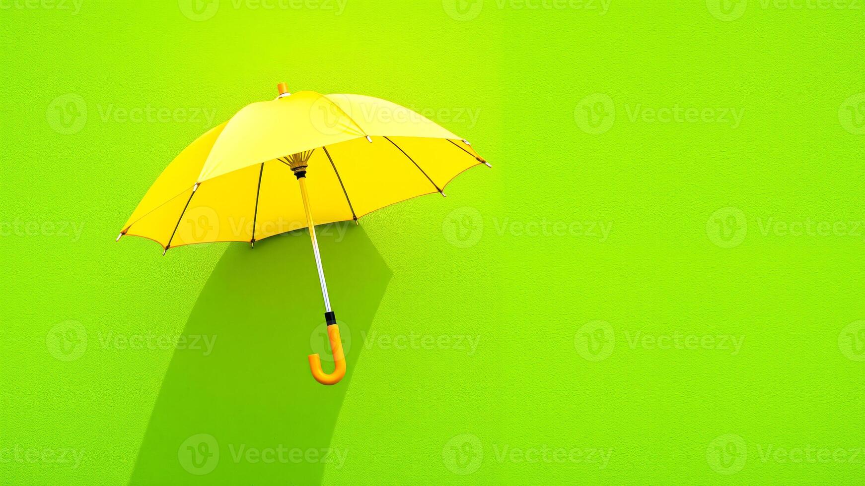yellow umbrella against a green wall photo