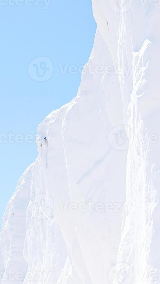 snowy mountainside with a clear blue sky photo