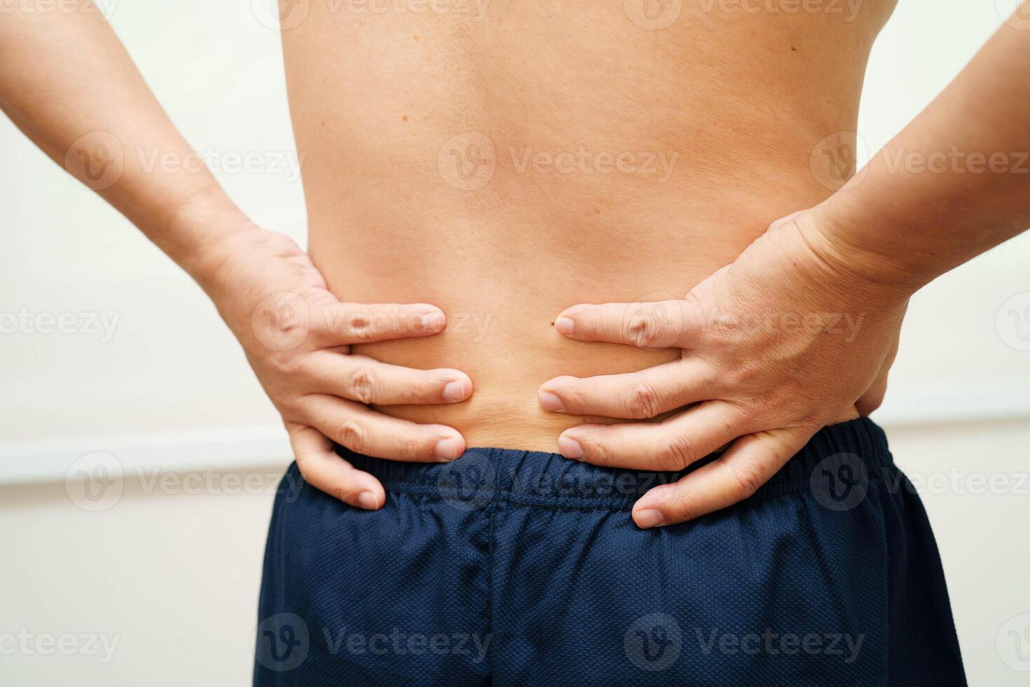 Asian man pain back muscle, spine and bone from accident. photo