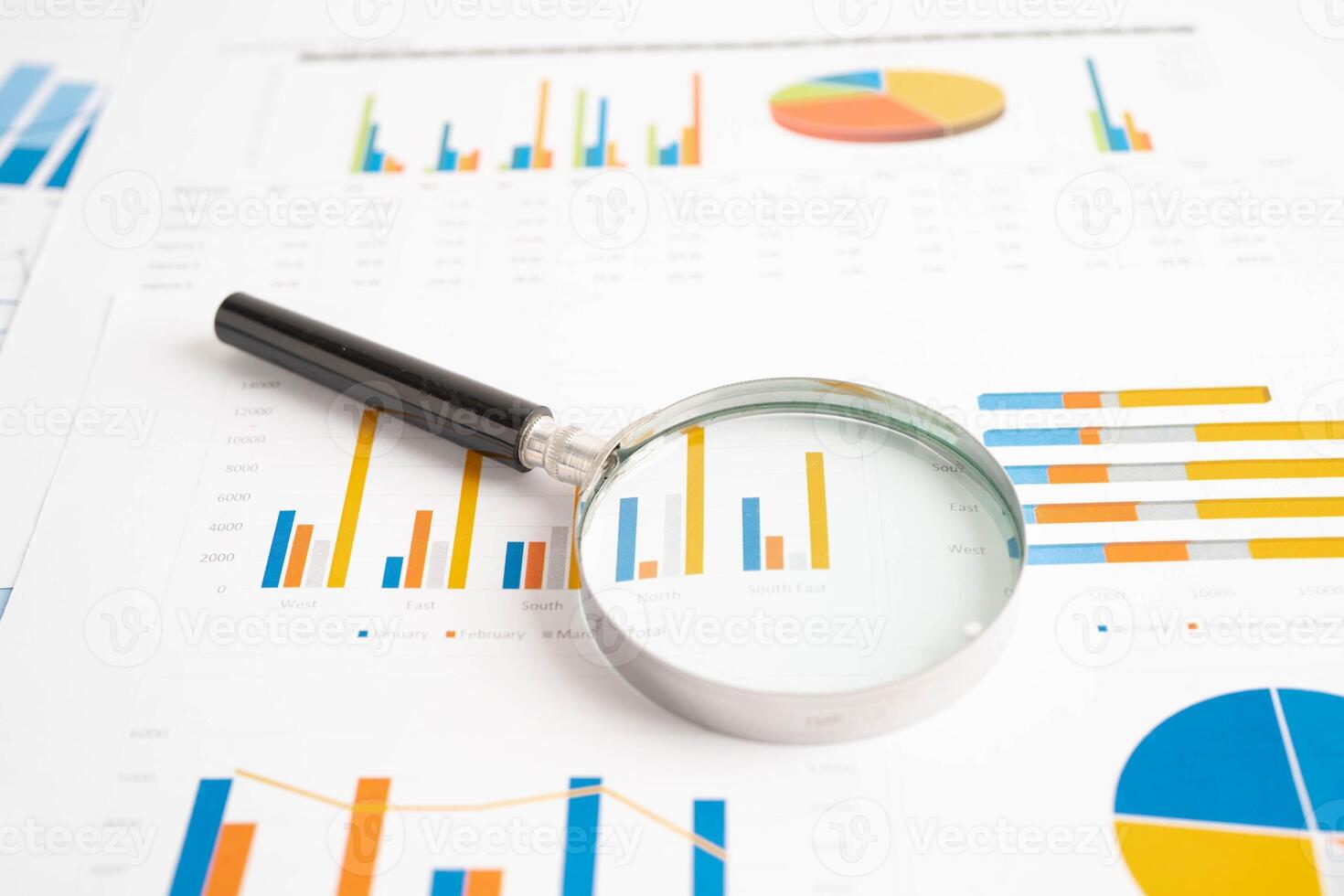 Magnifying glass on charts graphs paper. Financial development, Banking Account, Statistics, Investment Analytic research data economy. photo