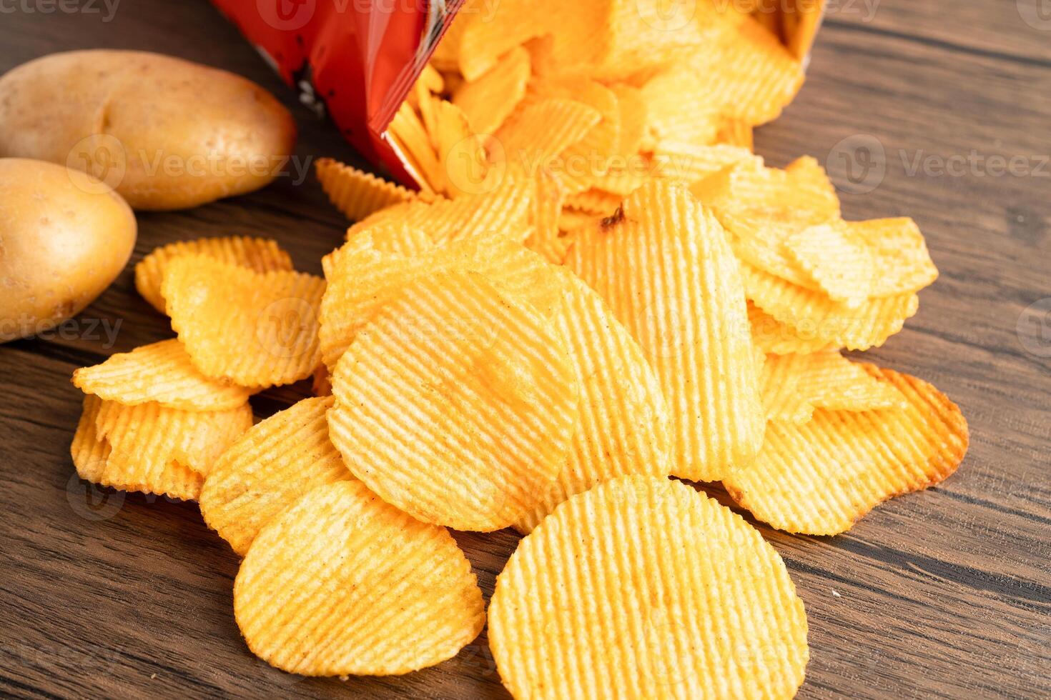 Potato chips , delicious BBQ seasoning spicy for crips, thin slice deep fried snack fast food. photo