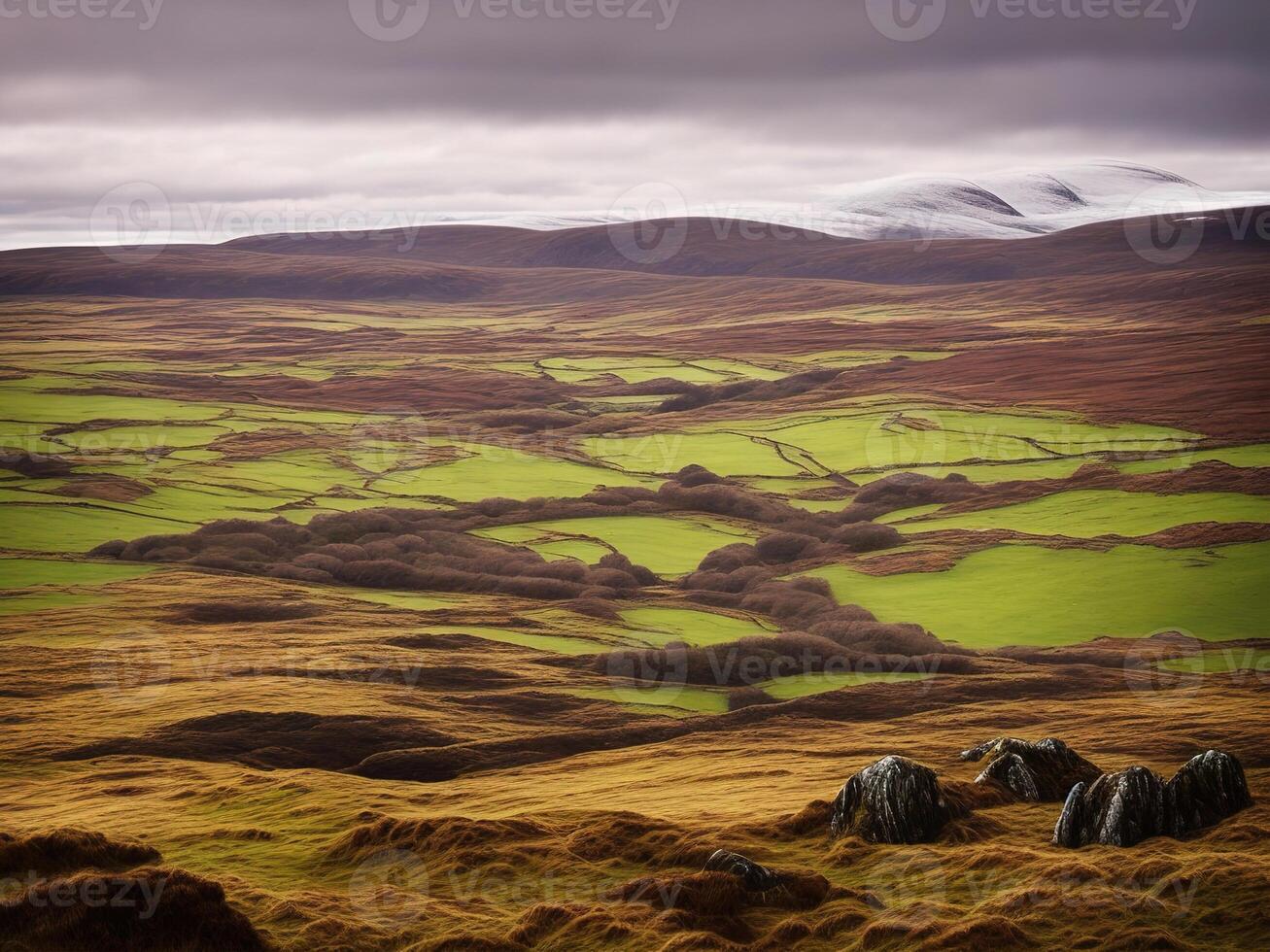 A view of a green landscape with hills and mountains photo
