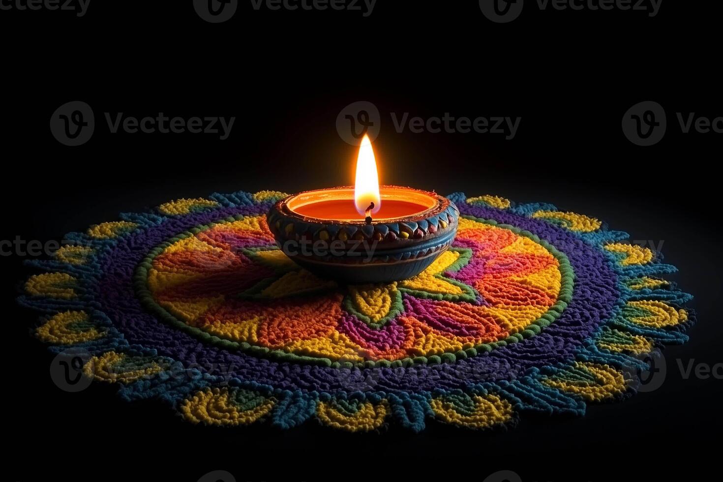 Diwali rangoli with colorful design and lit lamp photo