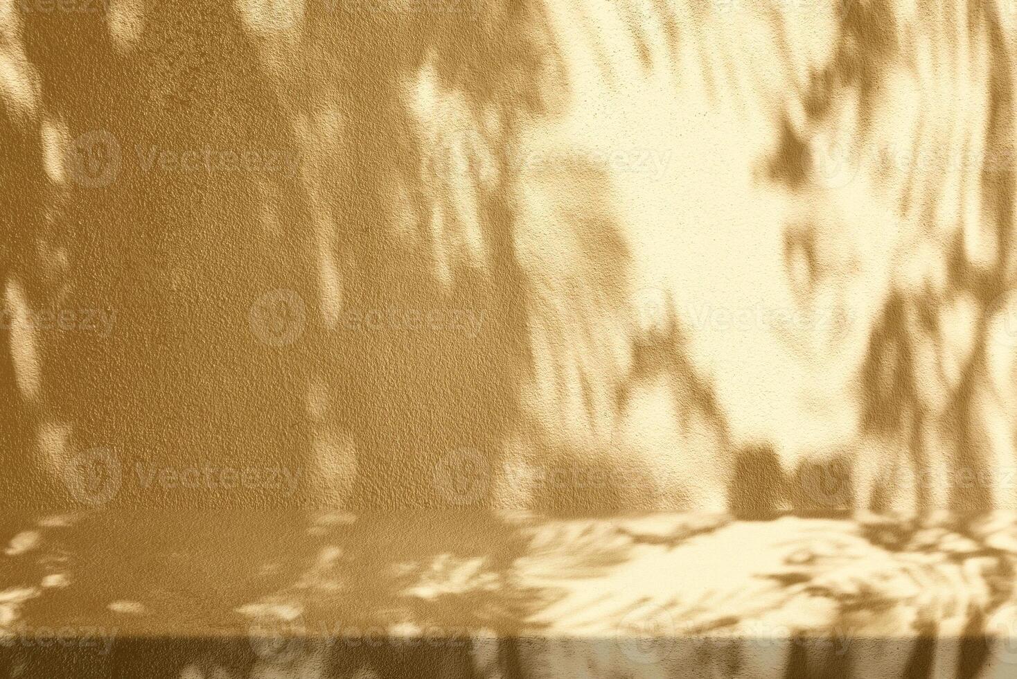 Gold Stucco Table with Nature Shadow on Concrete Wall Texture Background photo
