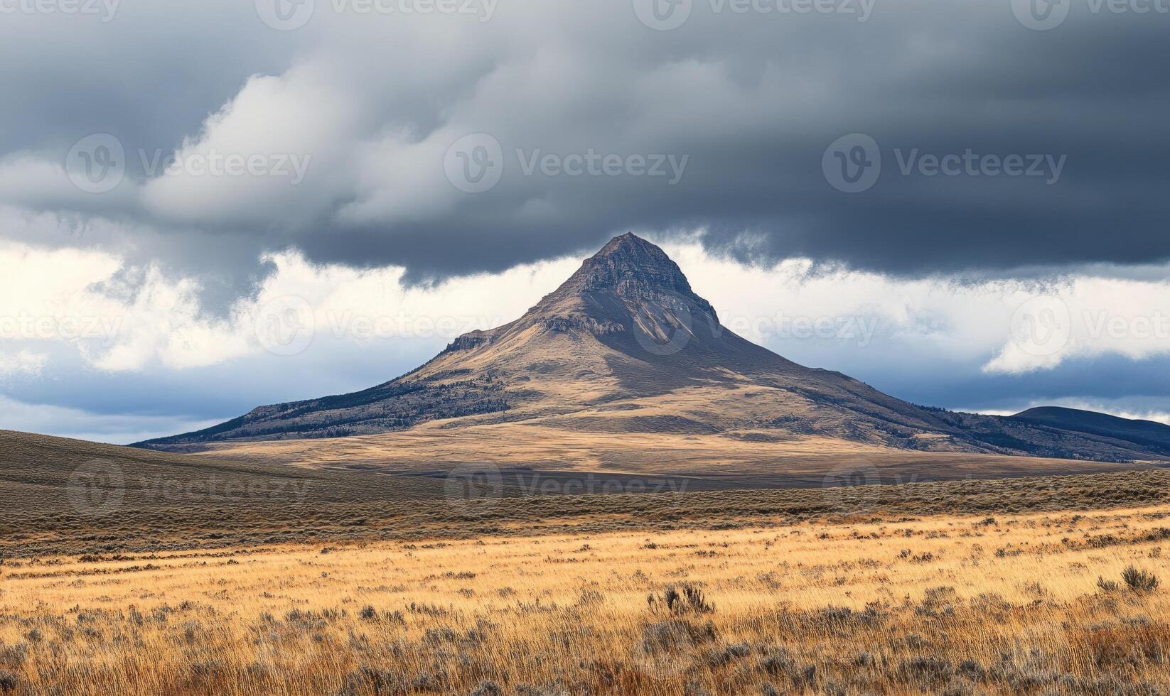 A mountain is in the background of a cloudy sky photo