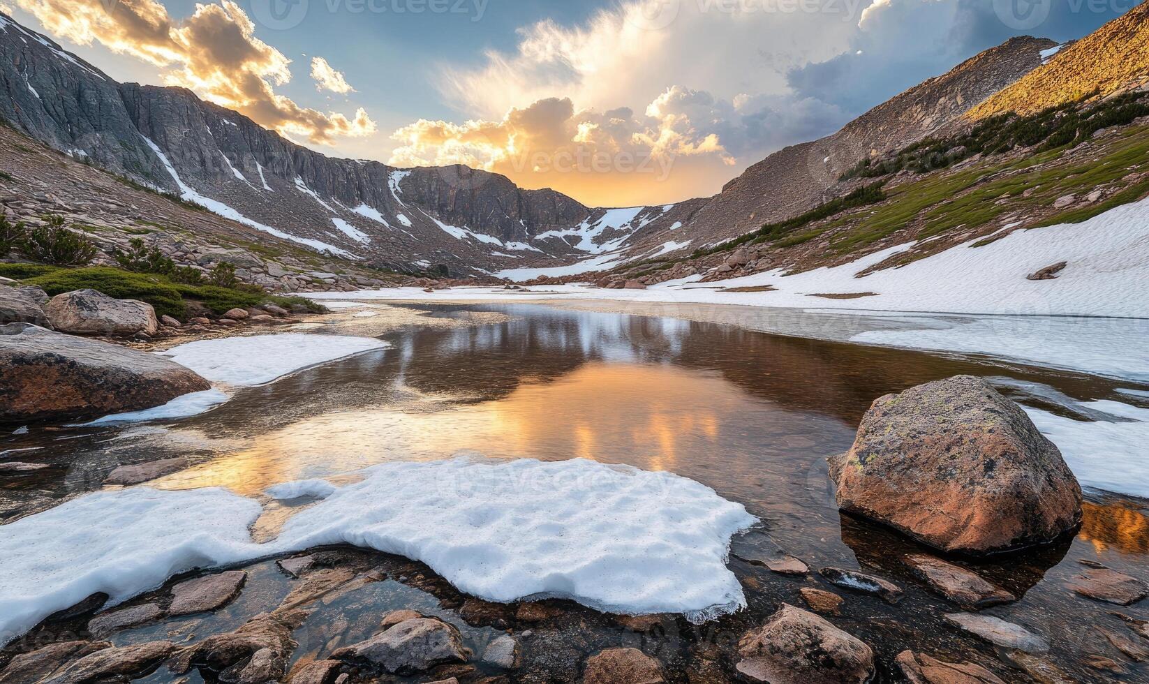 A beautiful mountain lake with a large rock in the foreground photo