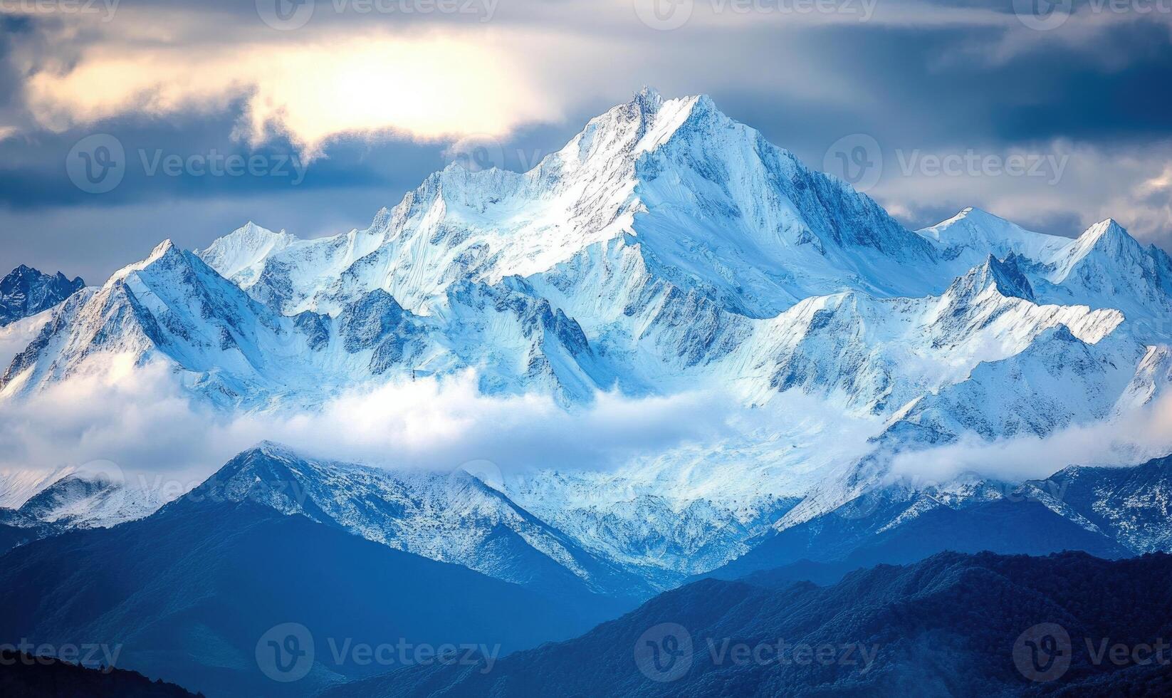 The mountains are covered in snow and the sky is cloudy photo