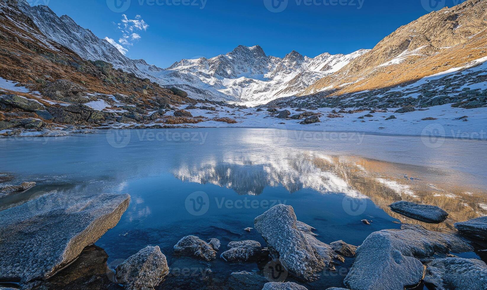 A large body of water is surrounded by rocks and mountains photo