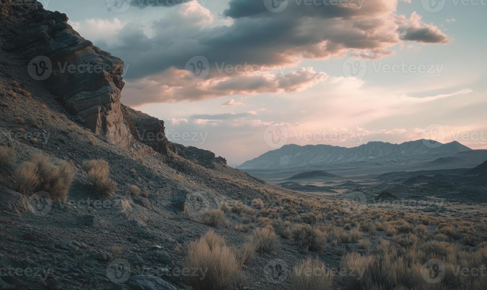 A rocky hillside with a cloudy sky in the background photo