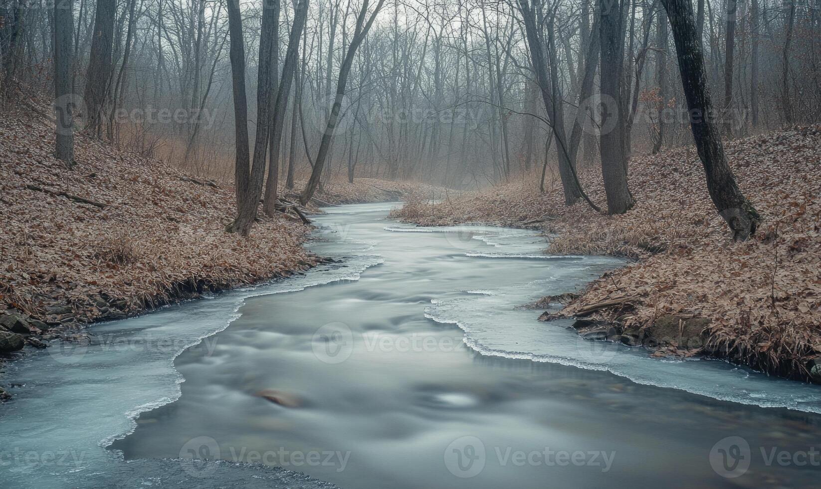 A frozen river with trees in the background photo