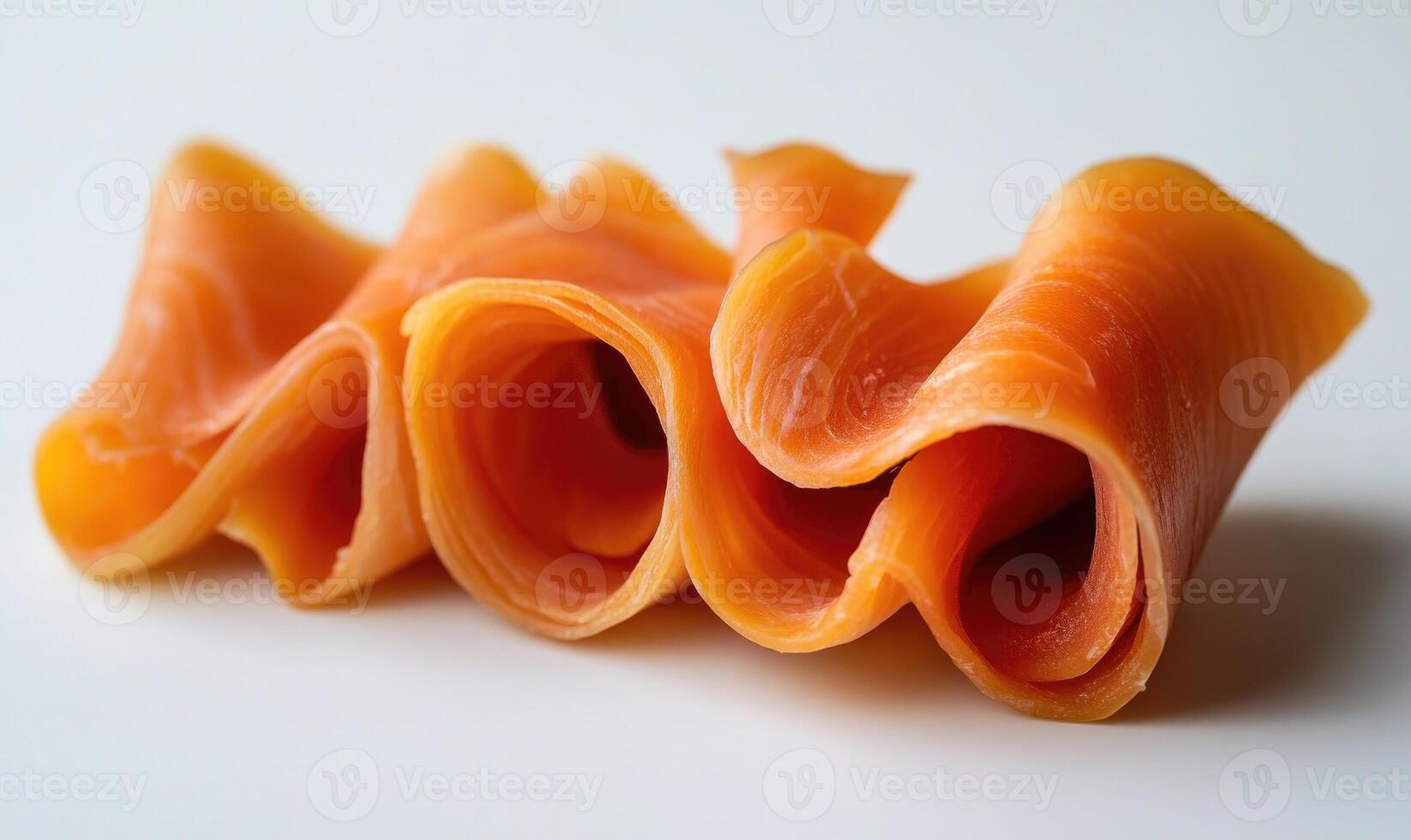 A piece of salmon is sliced into thin strips photo