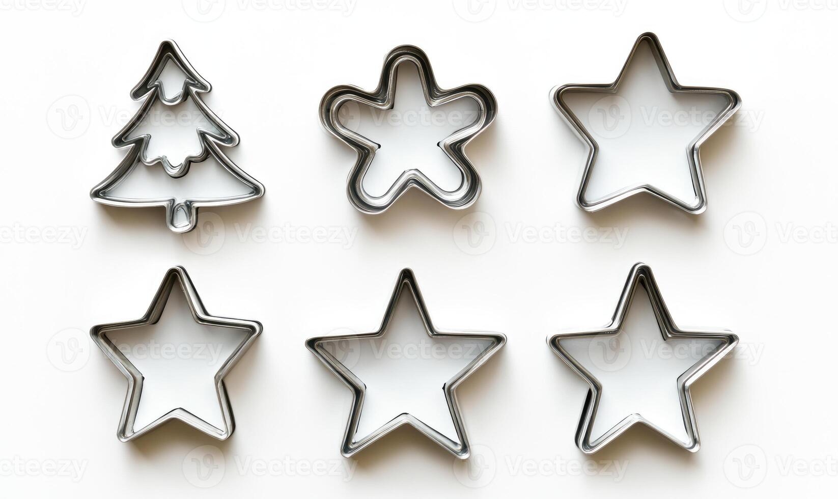 A set of cookie cutters in the shape of stars and a tree photo