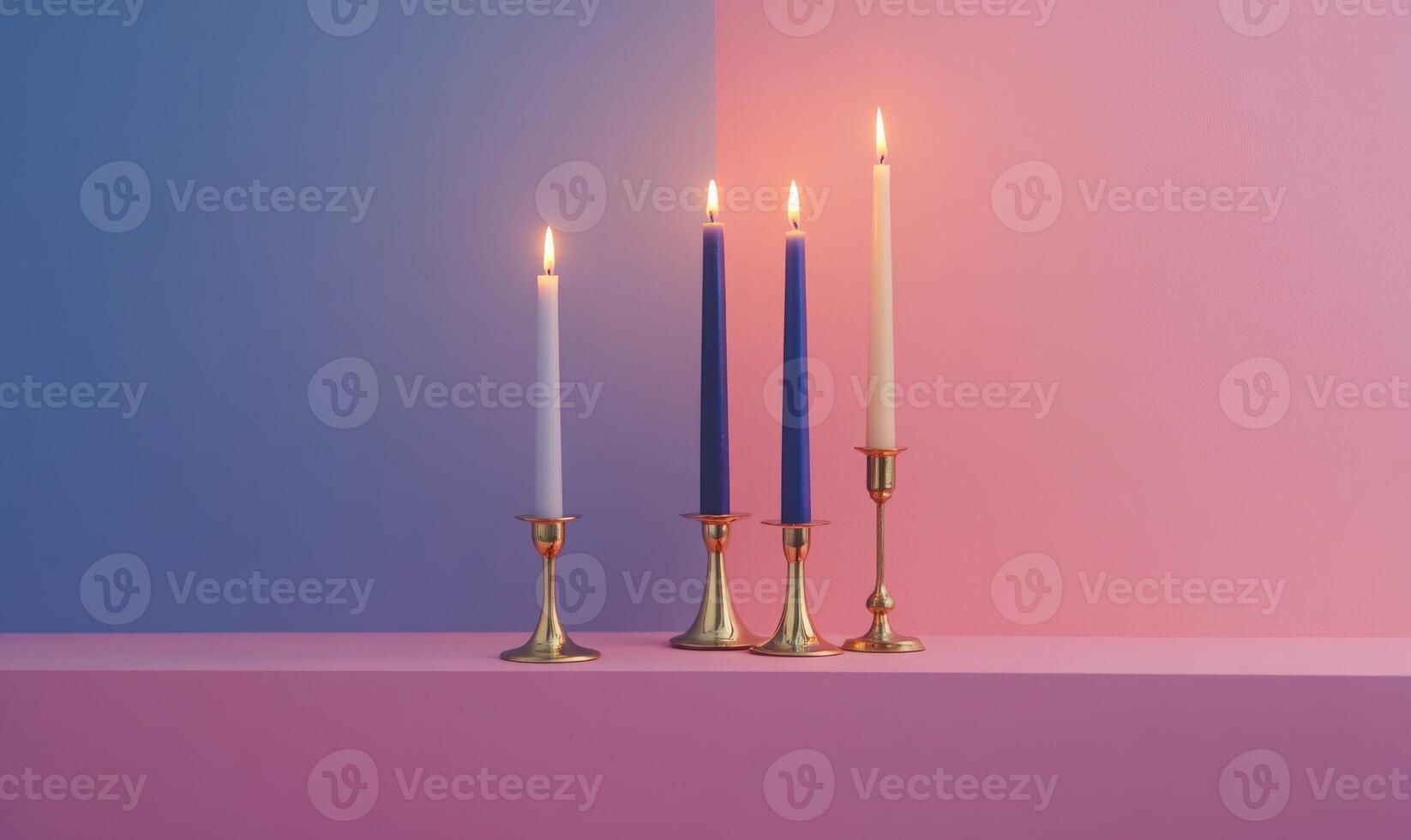 A row of four candles are lit on a table photo