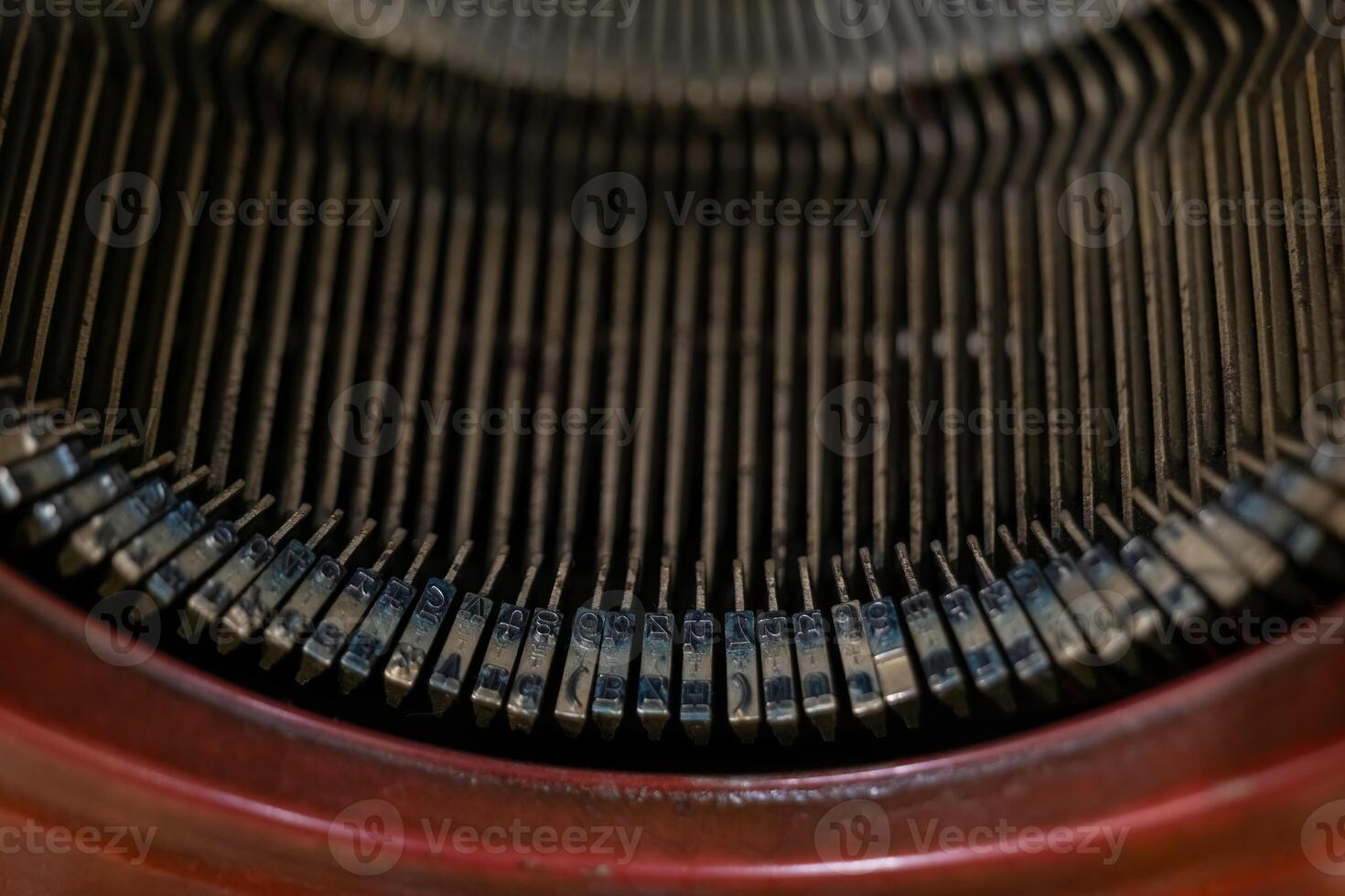 A close-up of the keys on a vintage typewriter, showing the intricate detail of the mechanism photo