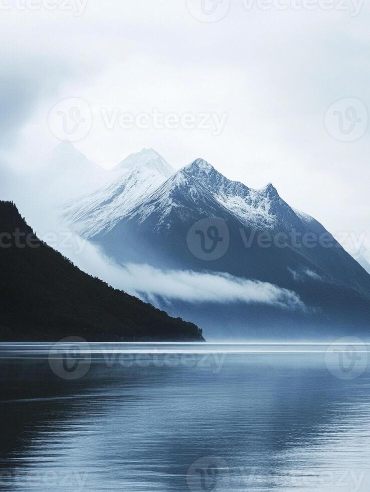 A mountain range is reflected in the water photo