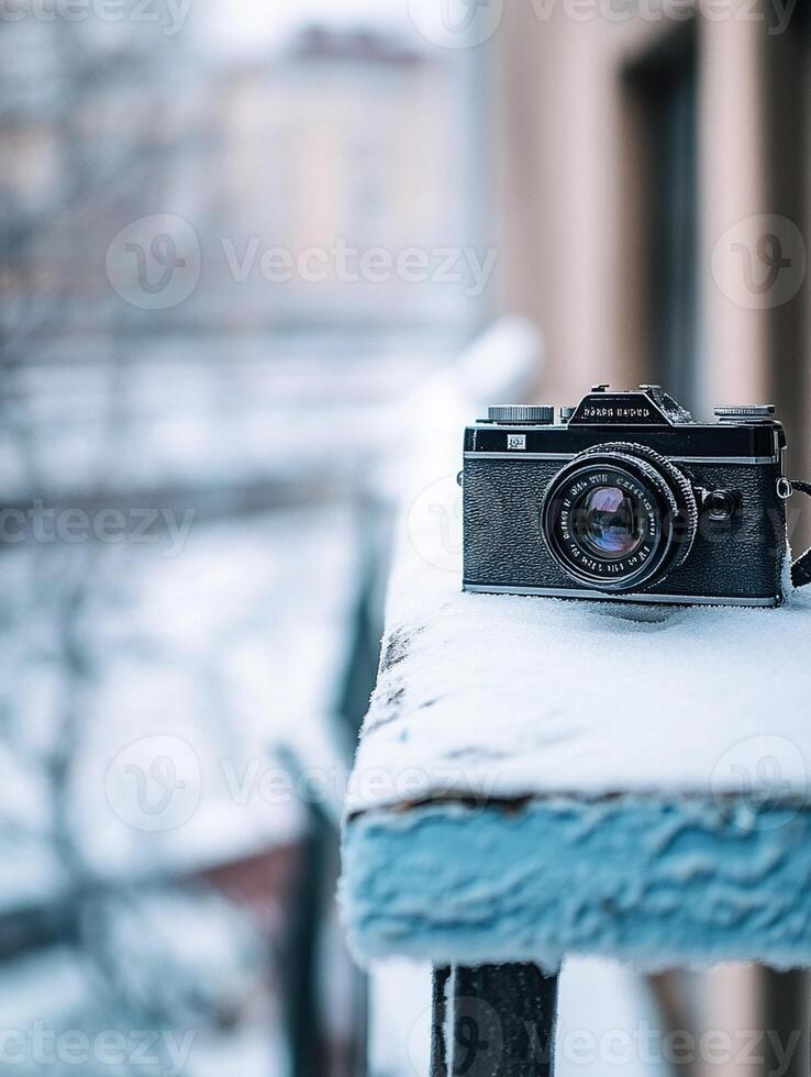 A camera sitting on a ledge in the snow photo