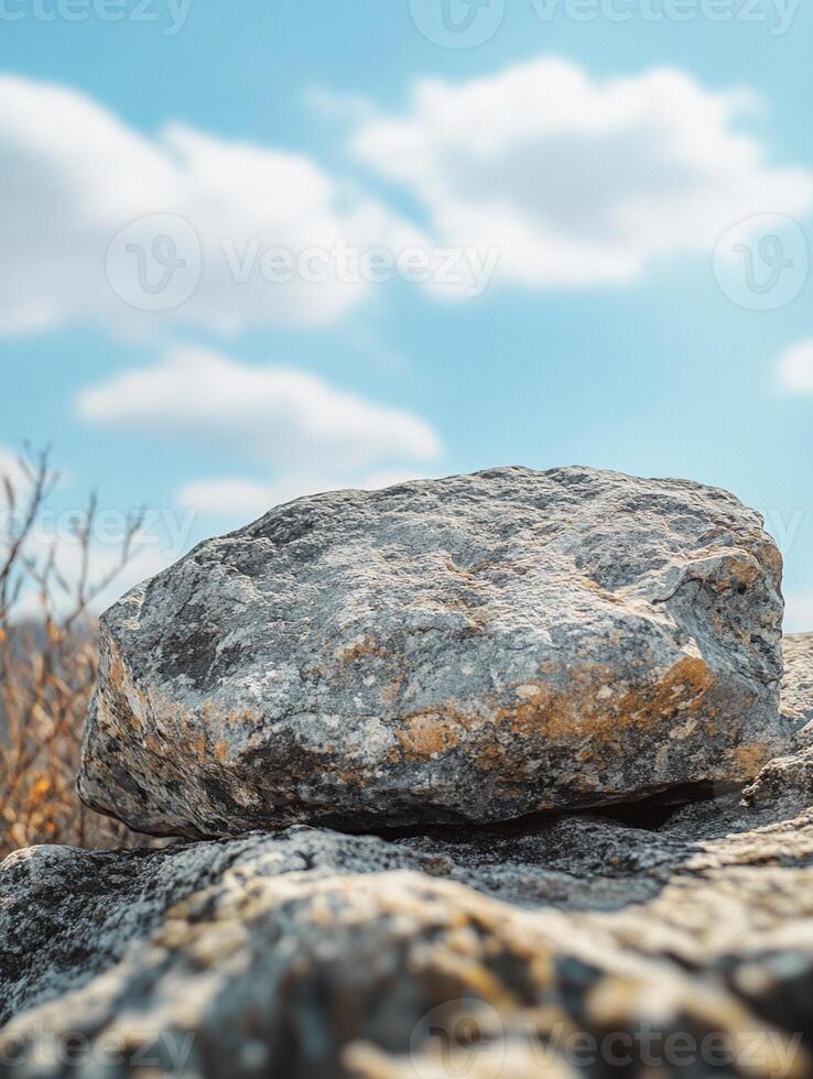 A rock sitting on top of a mountain photo