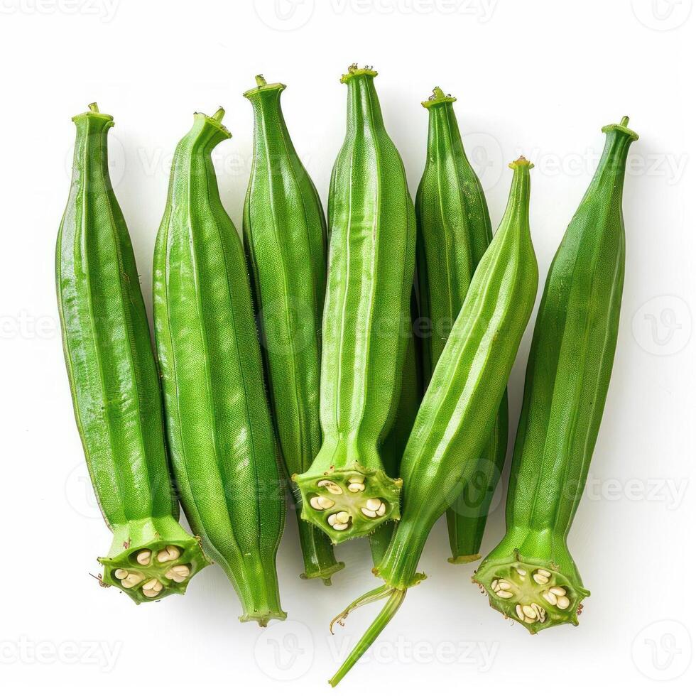 The image shows six green cucumber squashes arranged in a line against a white background. photo