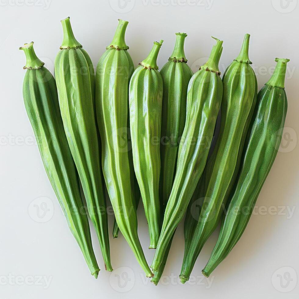 A bunch of green cucumbers lined up on a surface, showing their fresh and vibrant color. photo