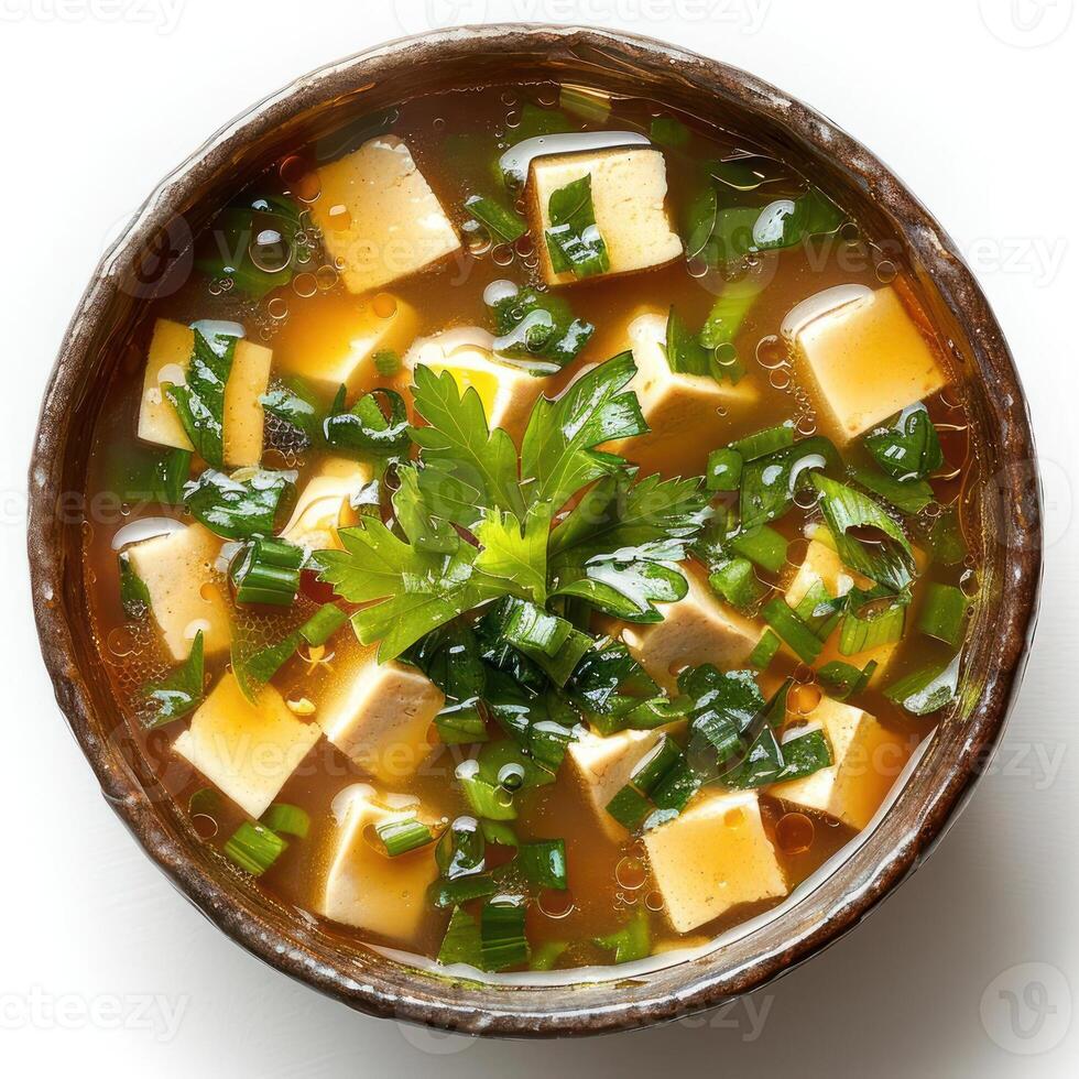 A bowl of hearty soup garnished with herbs and tofu. Perfect for a cold day. photo