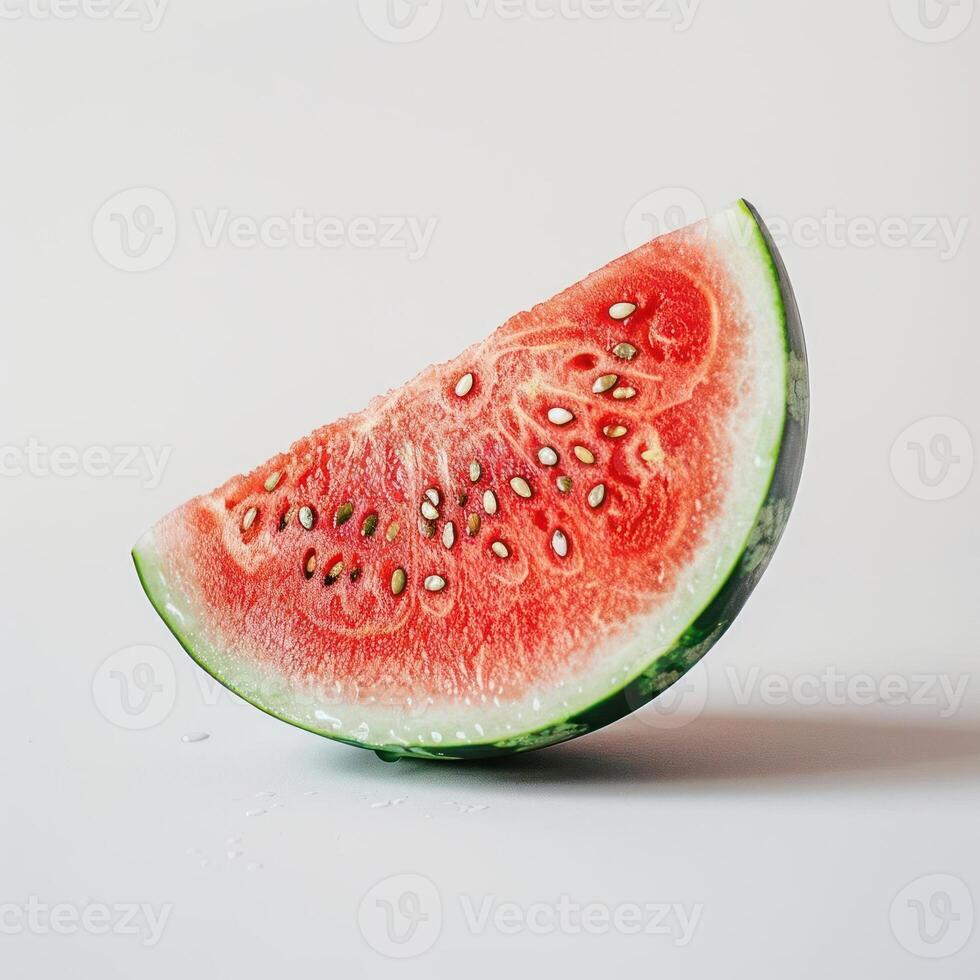 A slice of a watermelon with seeds visible and the rind intact. photo