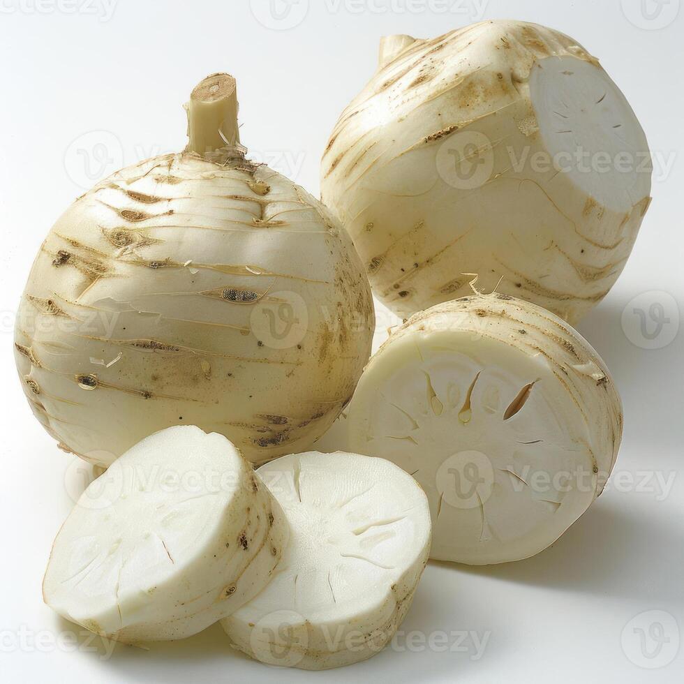 Several white squash bulbs on a table. They appear to be cut up, with some of the flesh removed. photo