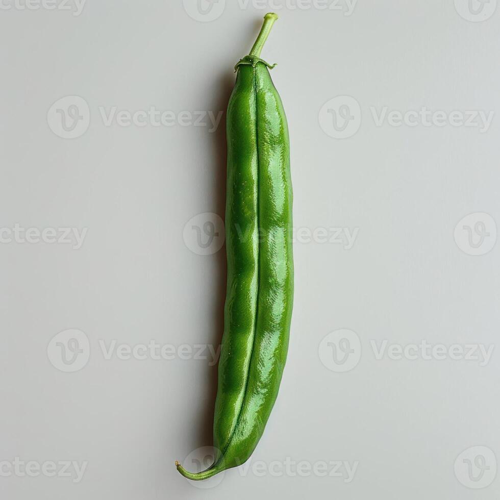 a picture of a fresh green pepper that appears to be unripe or in the early stages of ripening. photo