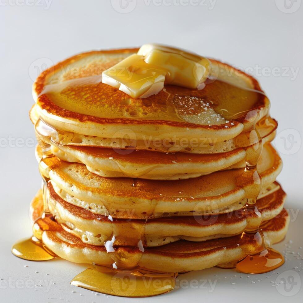 Pile of pancakes topped with syrup, butter and sugar. photo
