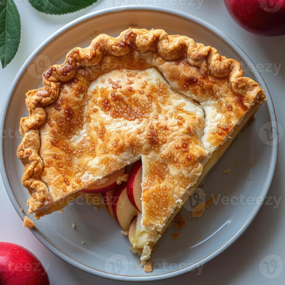 A slice of homemade apple pie with a golden crust, topped with fresh apples and sugar. photo