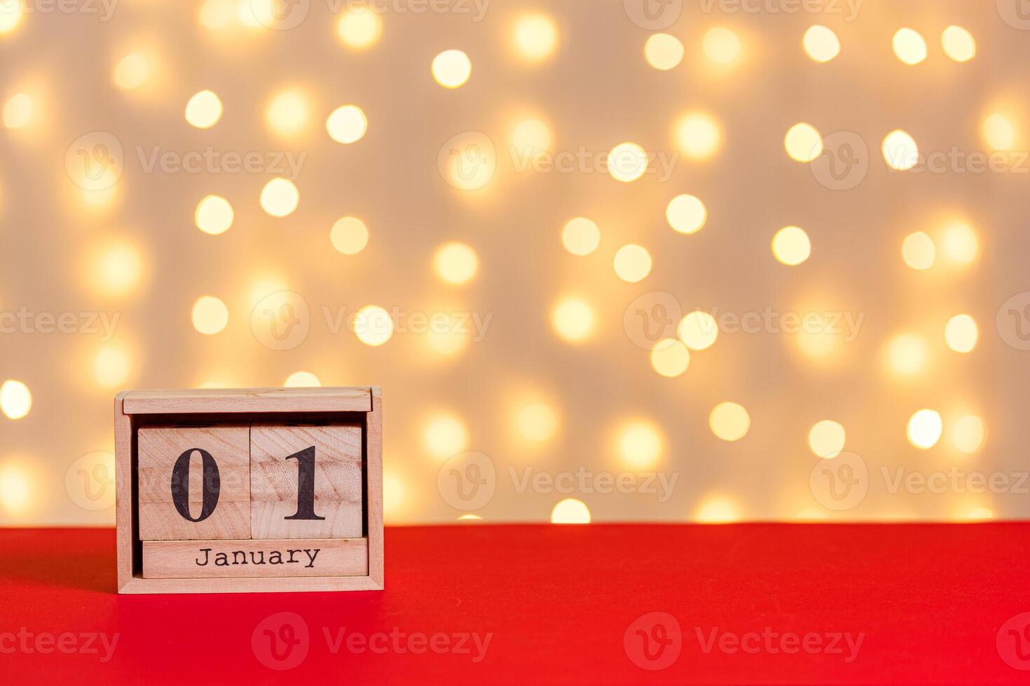 christmas, wooden calendar january 7 on red background and lights background photo