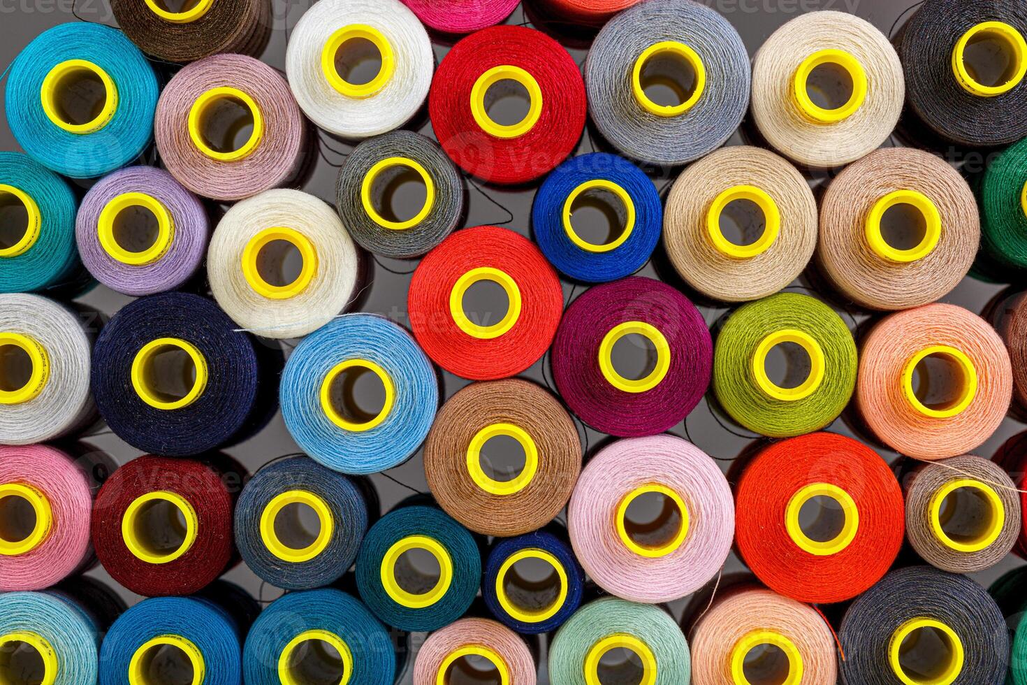 set of multi-colored spools of thread for sewing photo
