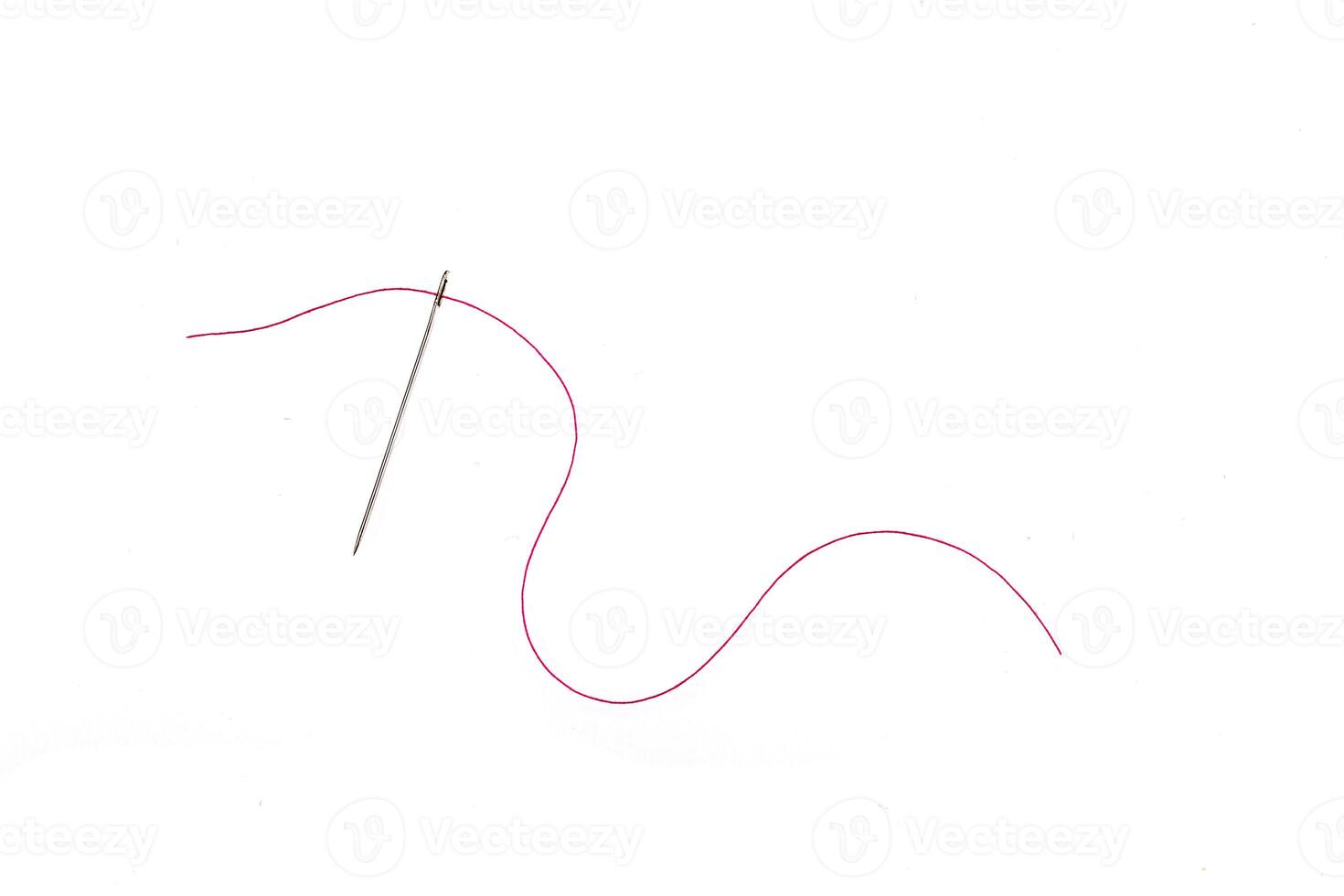needle and thread of red color on a white background photo