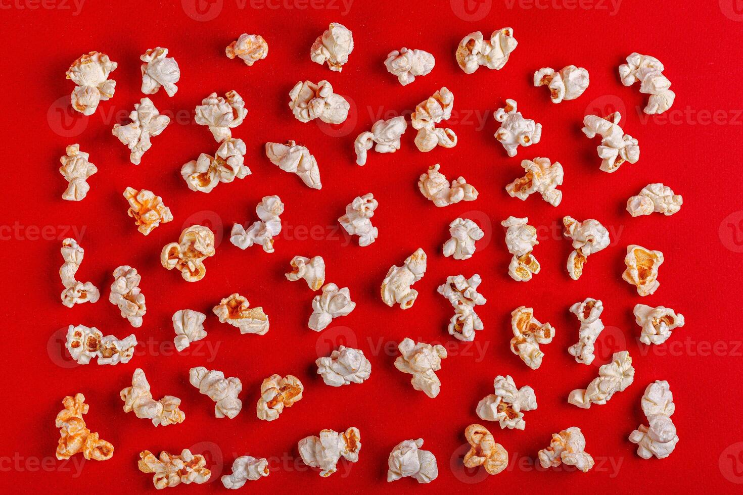 box with popcorn on a red background photo