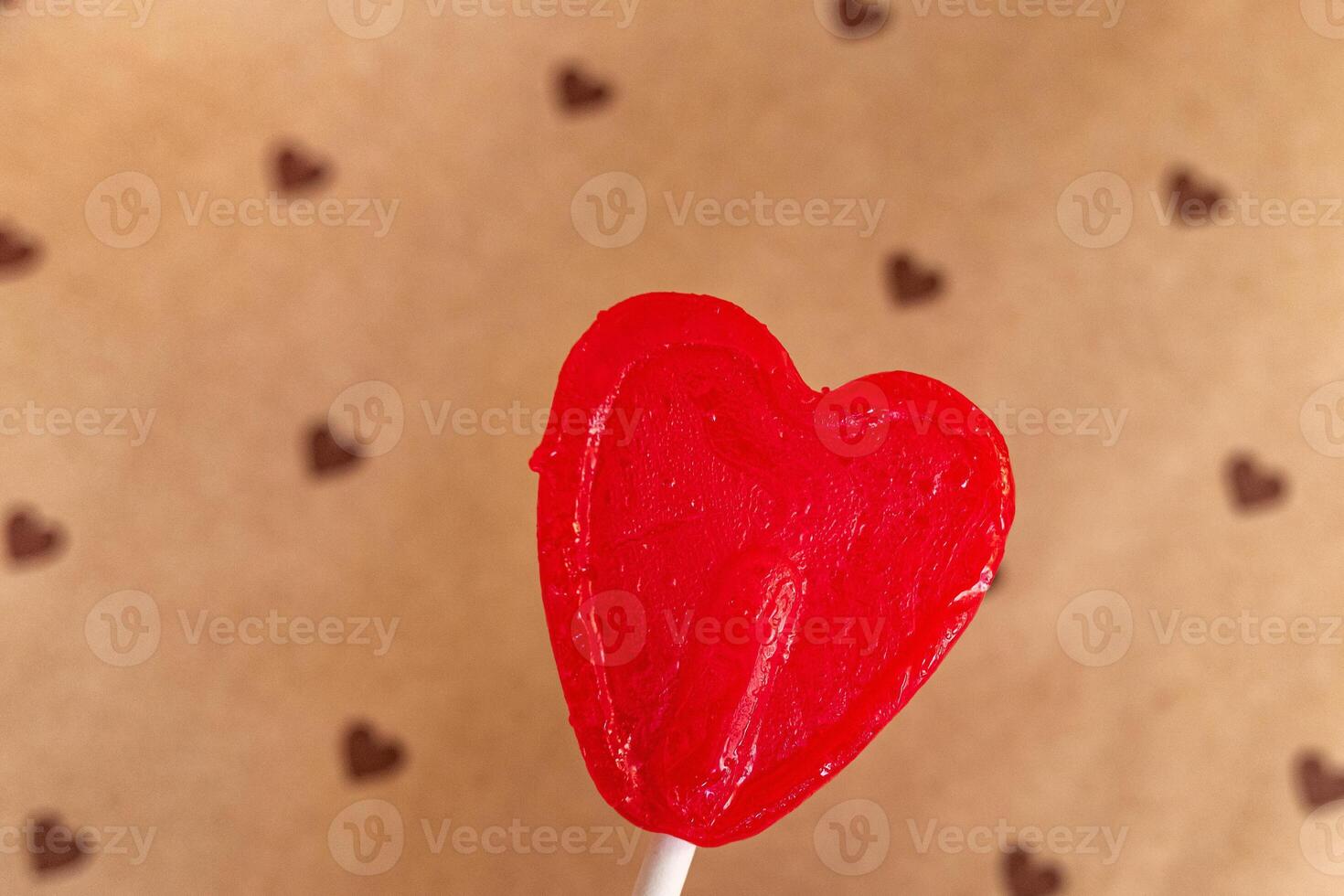 Representation of love through a heart-shaped lollipops on a hearts background. photo