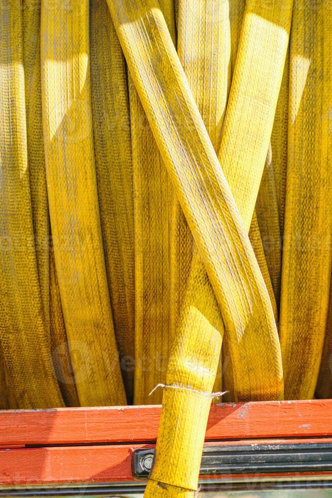 detail of the rolled up hose on the fire truck, textured background for fire fighter concept photo