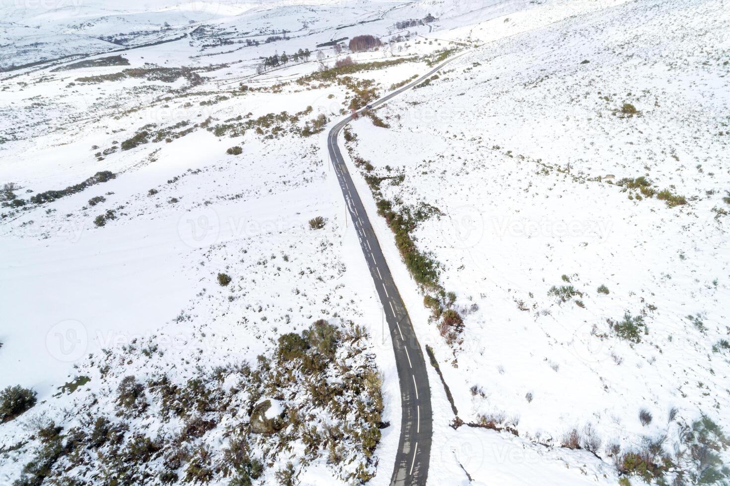 road in a snowy mountain landscape, drone aerial view. Seen from above. Background of winter concept photo