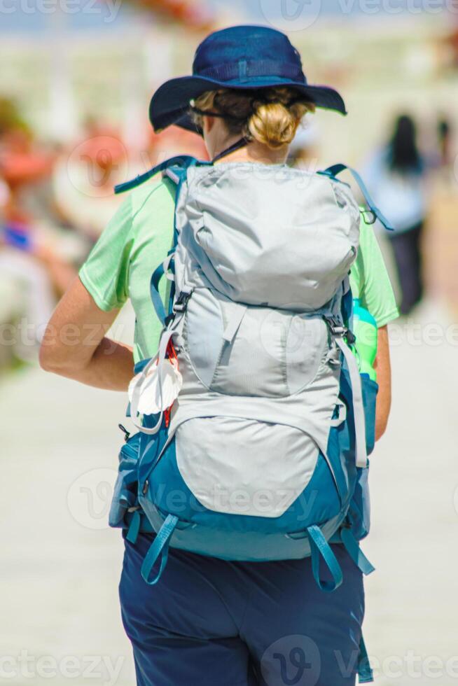 an unrecognizable pilgrim on her way to Santiago de Compostela, seen from the back, walking the route. Pilgrimage background concept photo