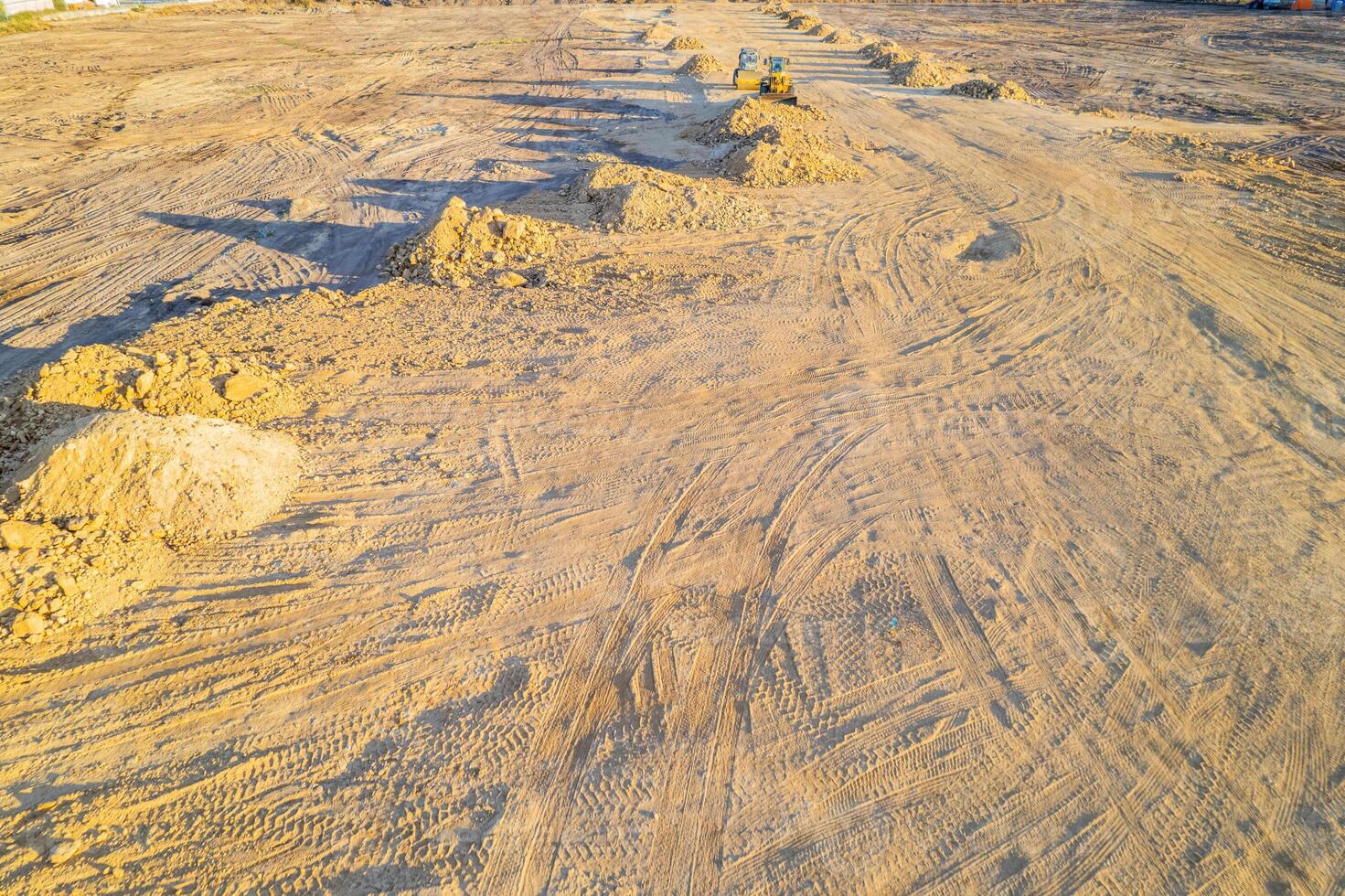 terrain in construction work moving earth with machines with huge pile of earth excavated by a construction site photo