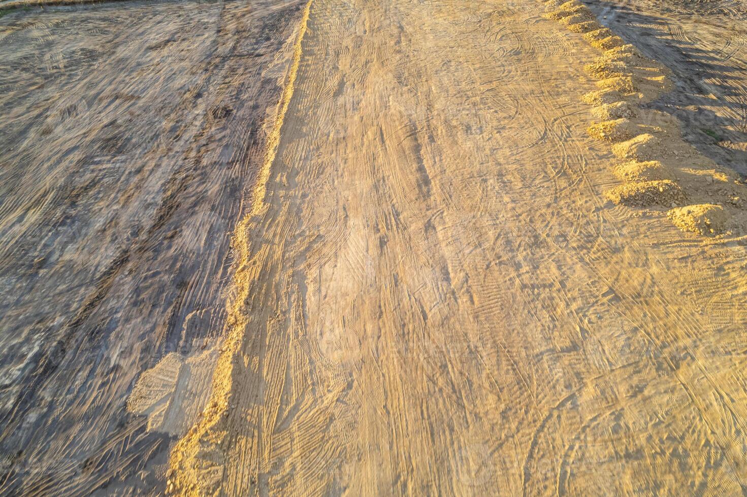 huge pile of earth excavated by a construction site, piles of excavated soil on a construction site photo