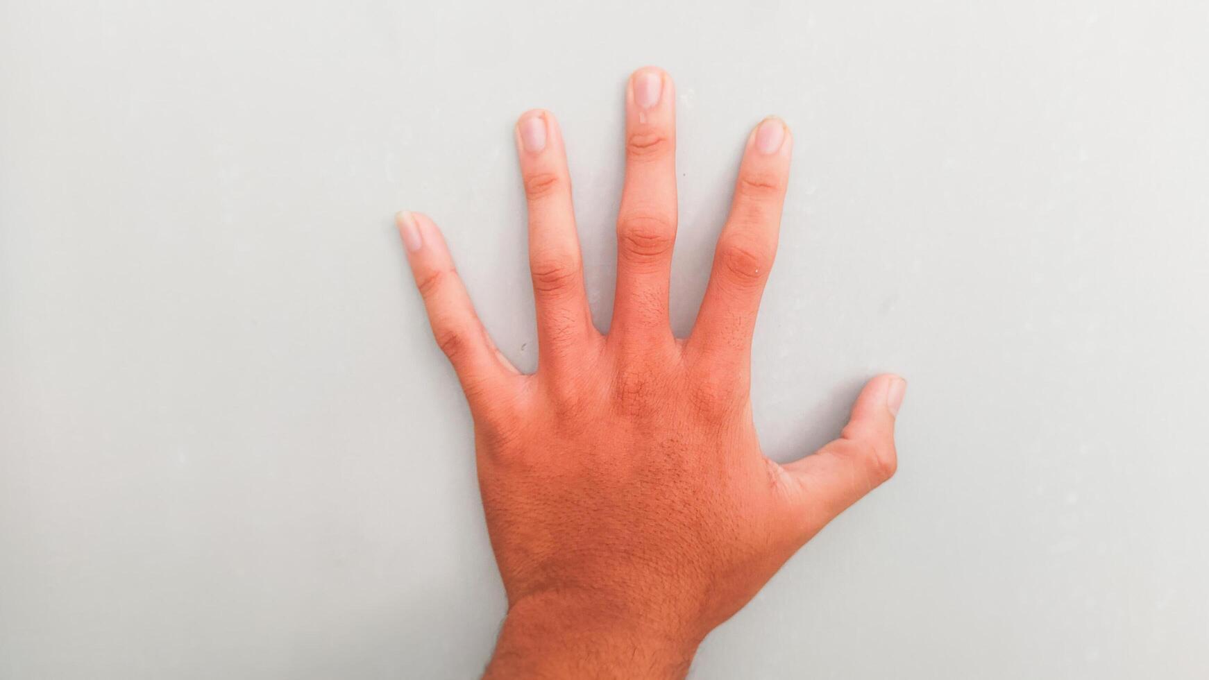 a person's hand on a gray background photo