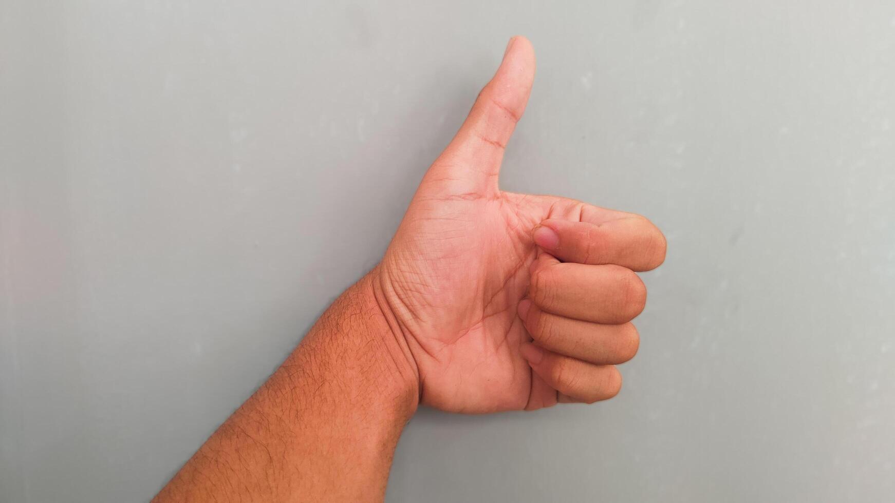 a person's hand on a gray background photo