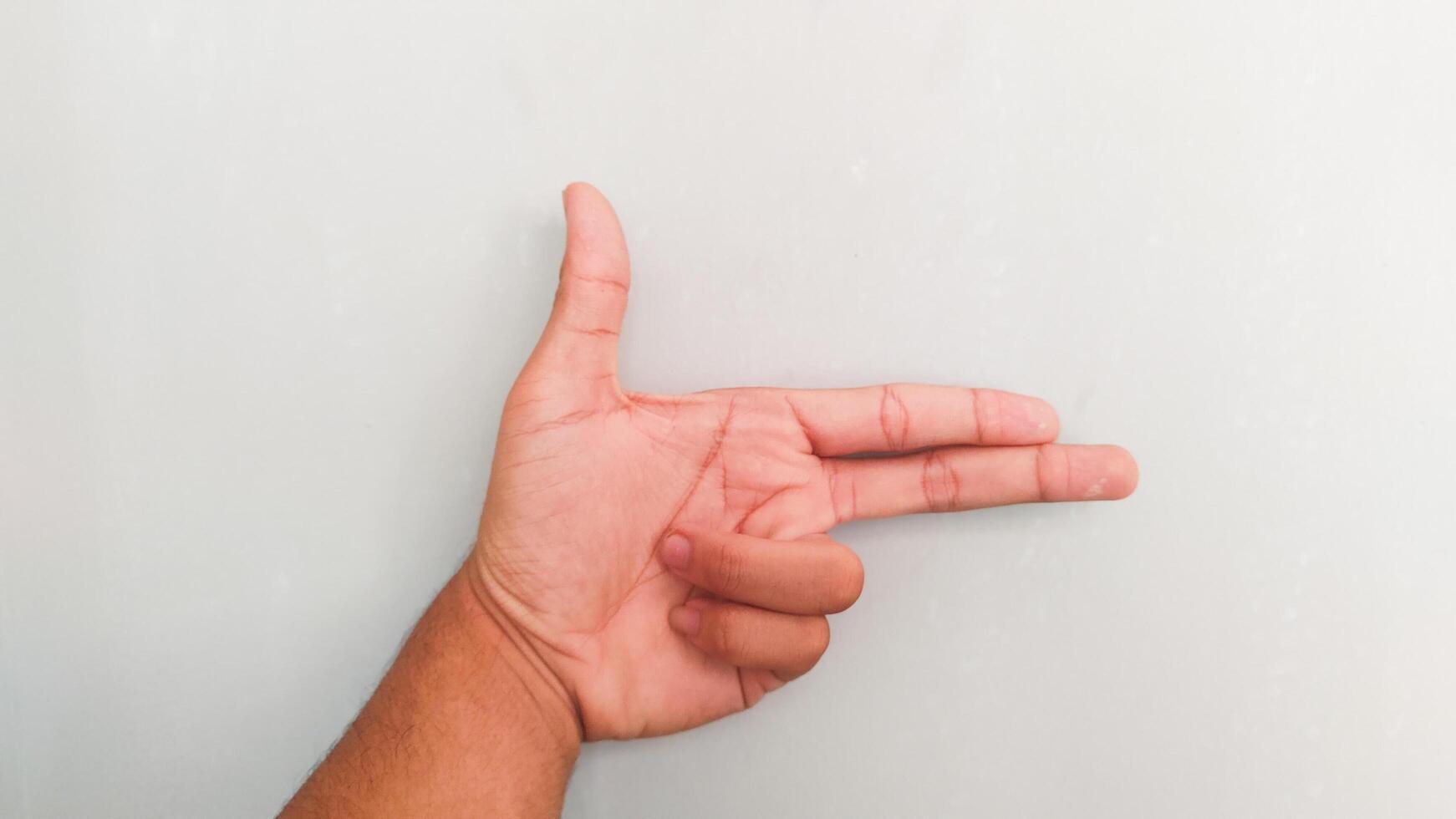 a person's hand on a gray background photo