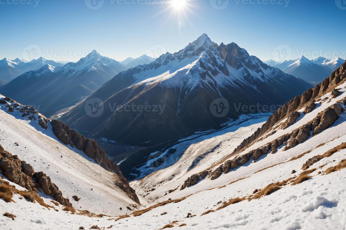 Majestic Mountain Range with Snow Covered Peaks and Sunny Sky photo