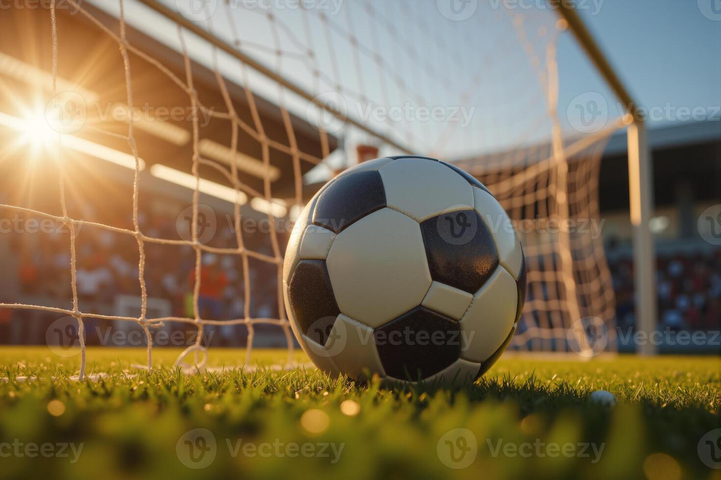 Soccer Ball in Goal Net with Sunset Glow photo