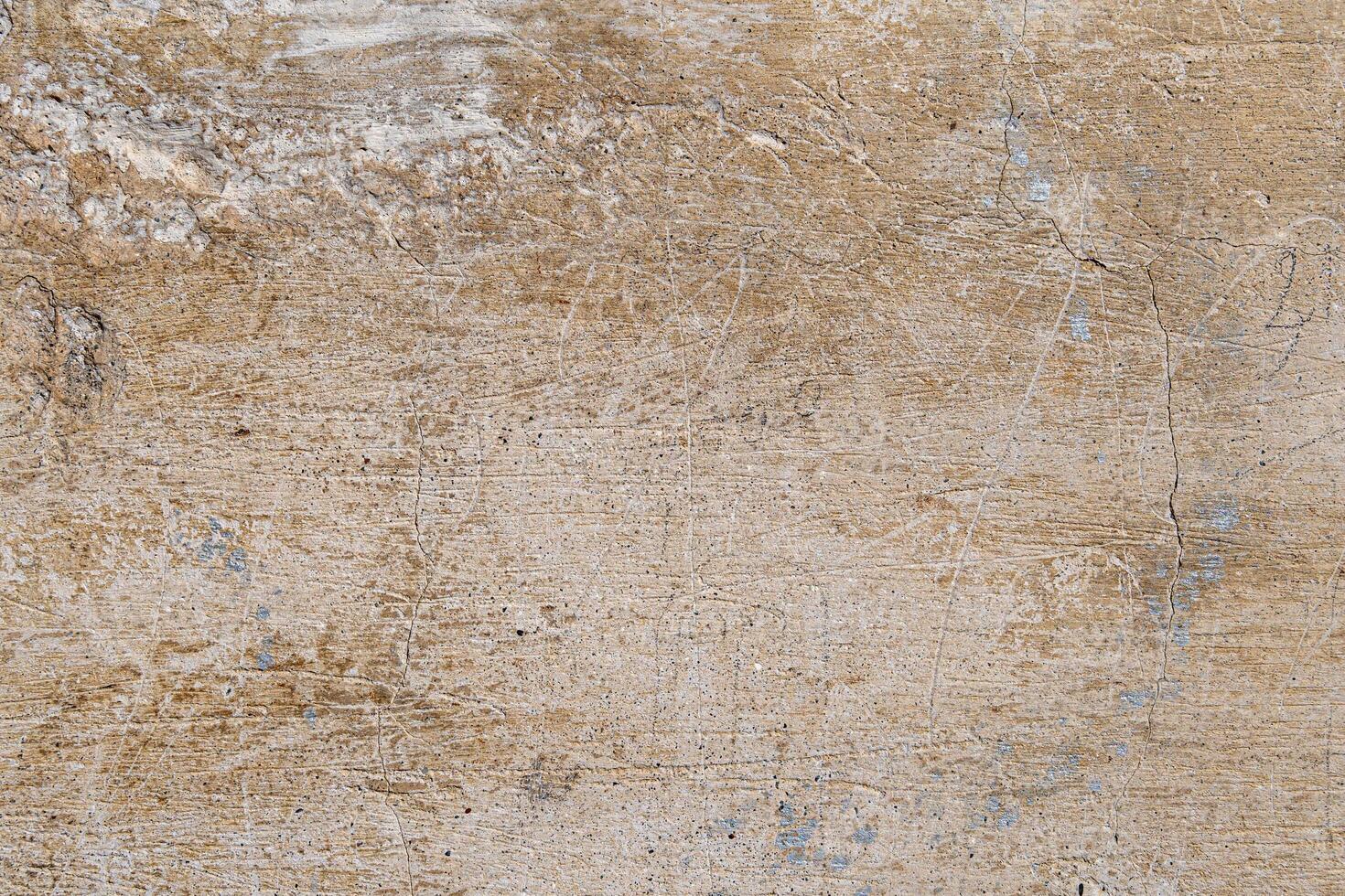 A wall with a rough texture and a few holes. The wall is brown and has a somewhat worn appearance photo